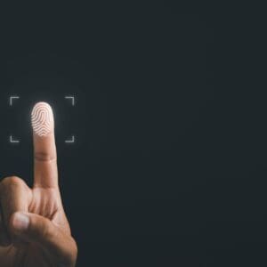 A finger taps a digital interface, emphasizing the fingerprint icon against a dark backdrop.