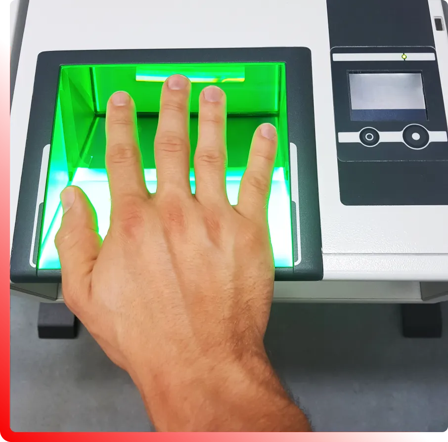 A hand is placed on a fingerprint scanner with a green light, next to a control panel with buttons.